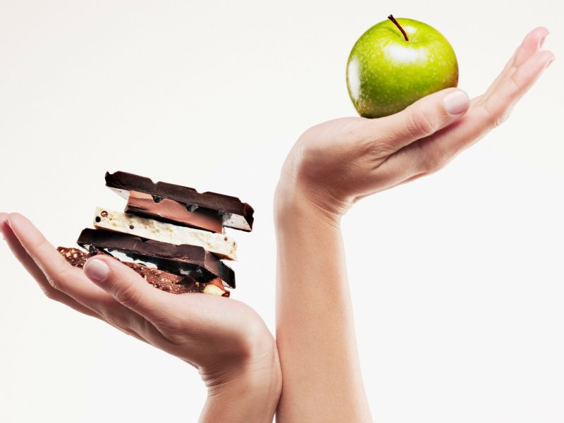 woman-cupping-green-apple-above-chocolate-bars-103332848-59e3f1fa03f402001000daef
